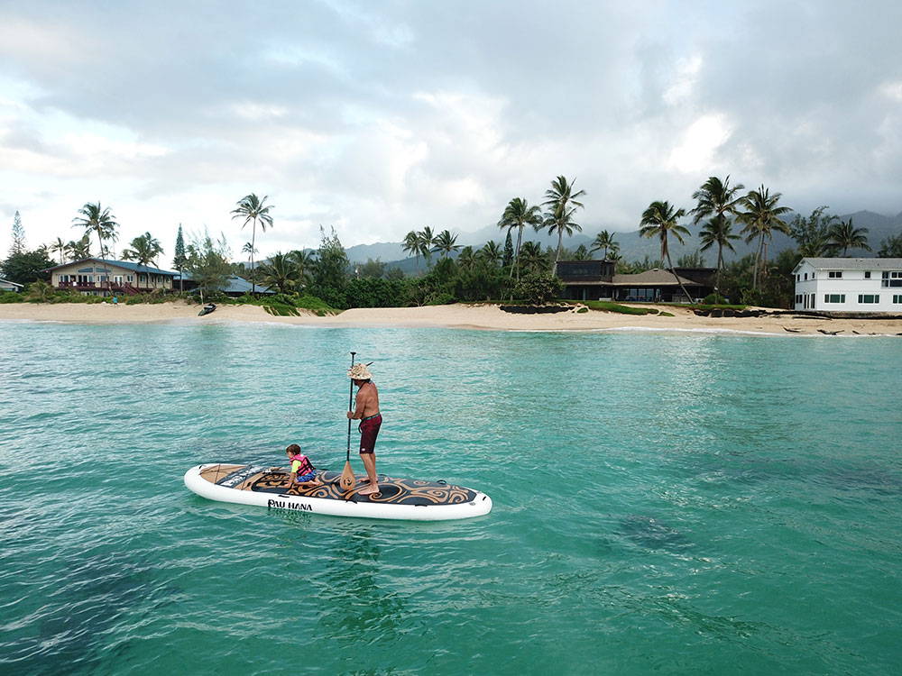a farther and son paddleboarding in Hawaii
