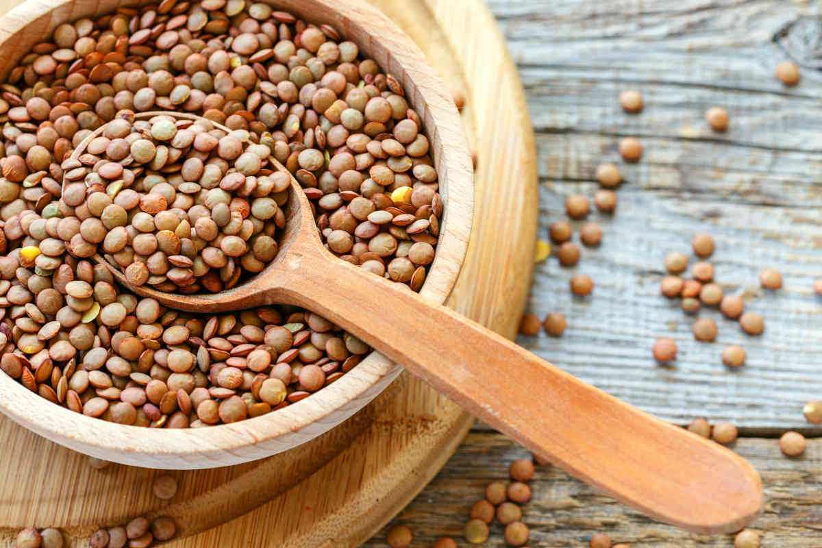 Lentils and spoon in a wooden bowl close up on an old table | Eat These Foods to Improve Mental Awareness | food for brain power