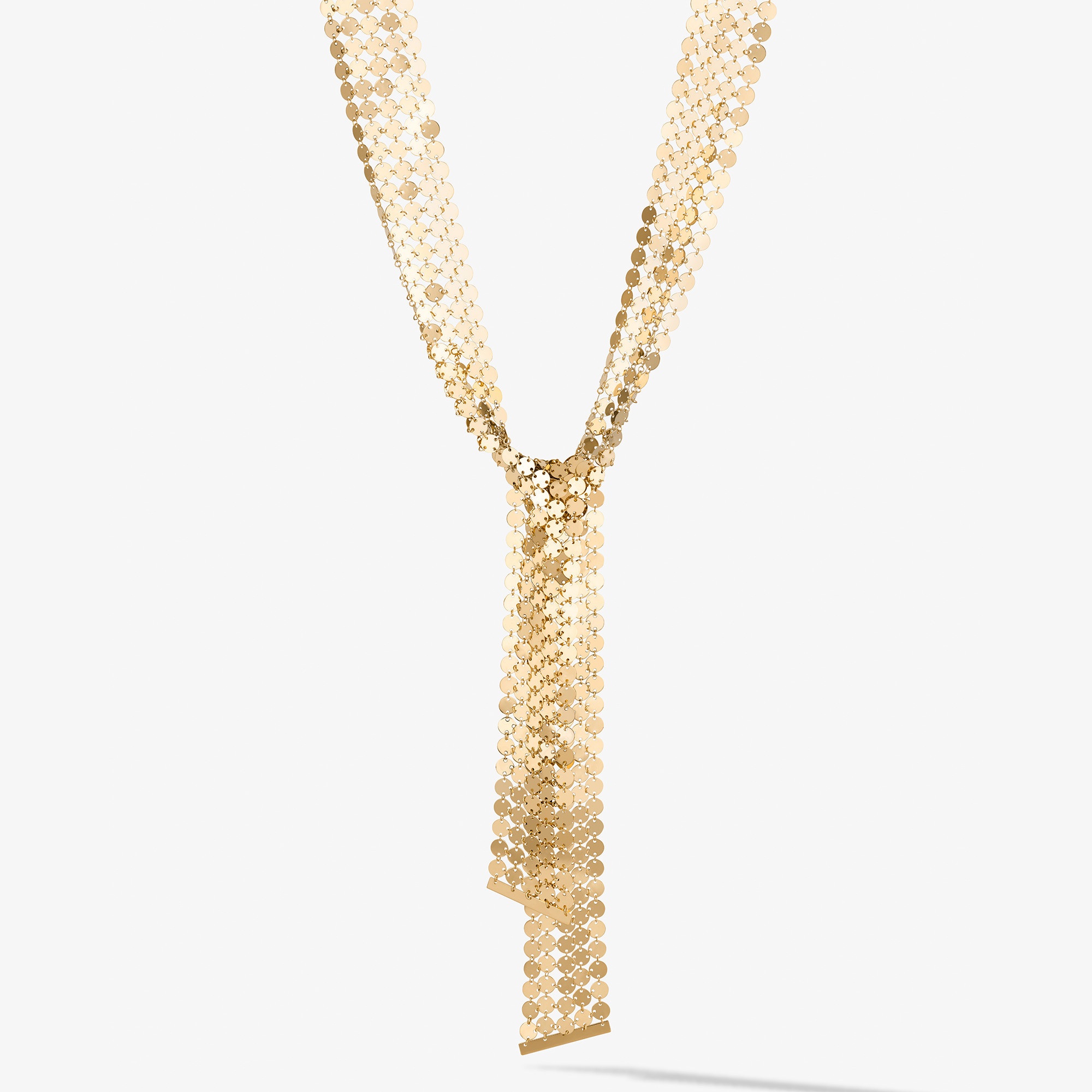 Gold chain necklace with a decorative tassel pendant.