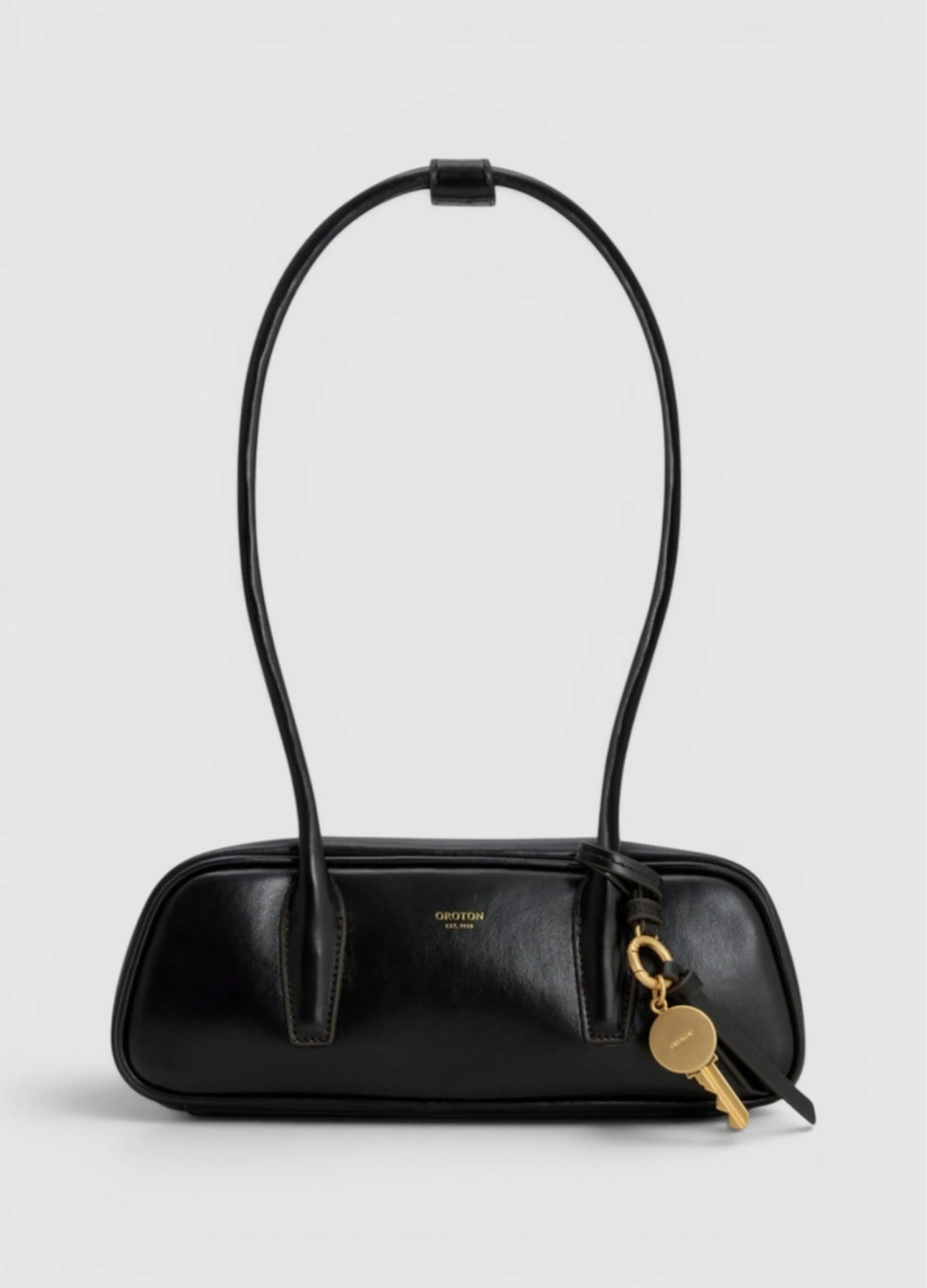 Black leather handbag with a long handle and keychain.