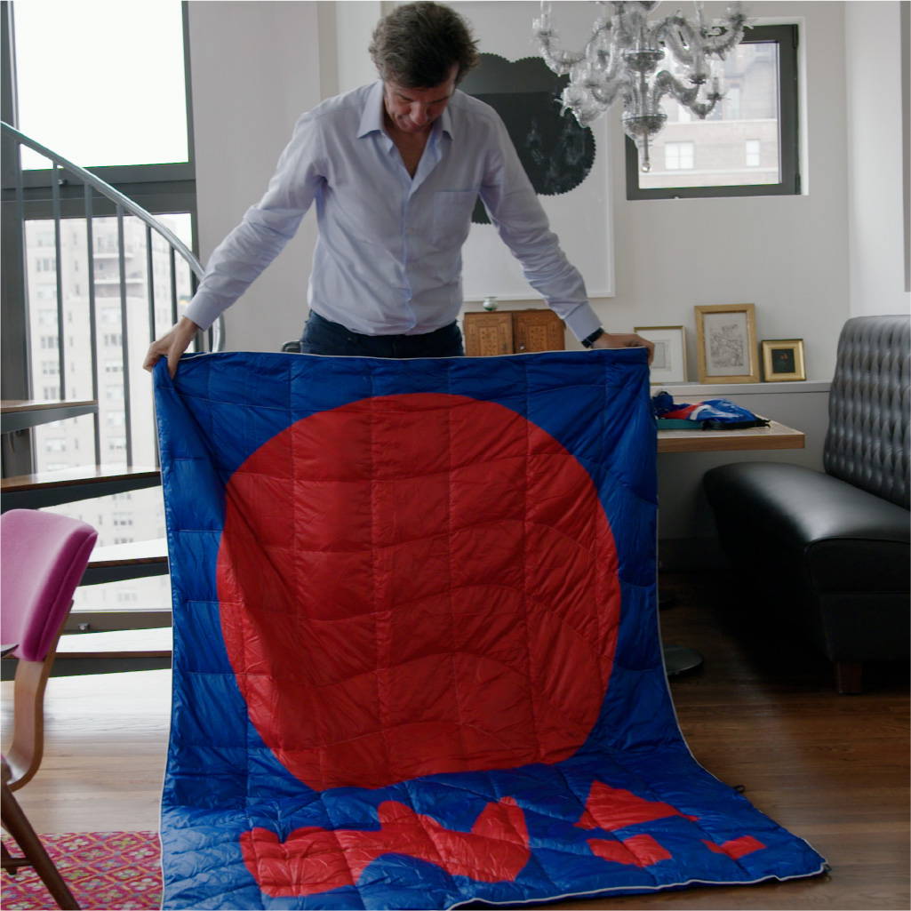 Stefan Sagmeister in his apartment with a Rumpl blanket