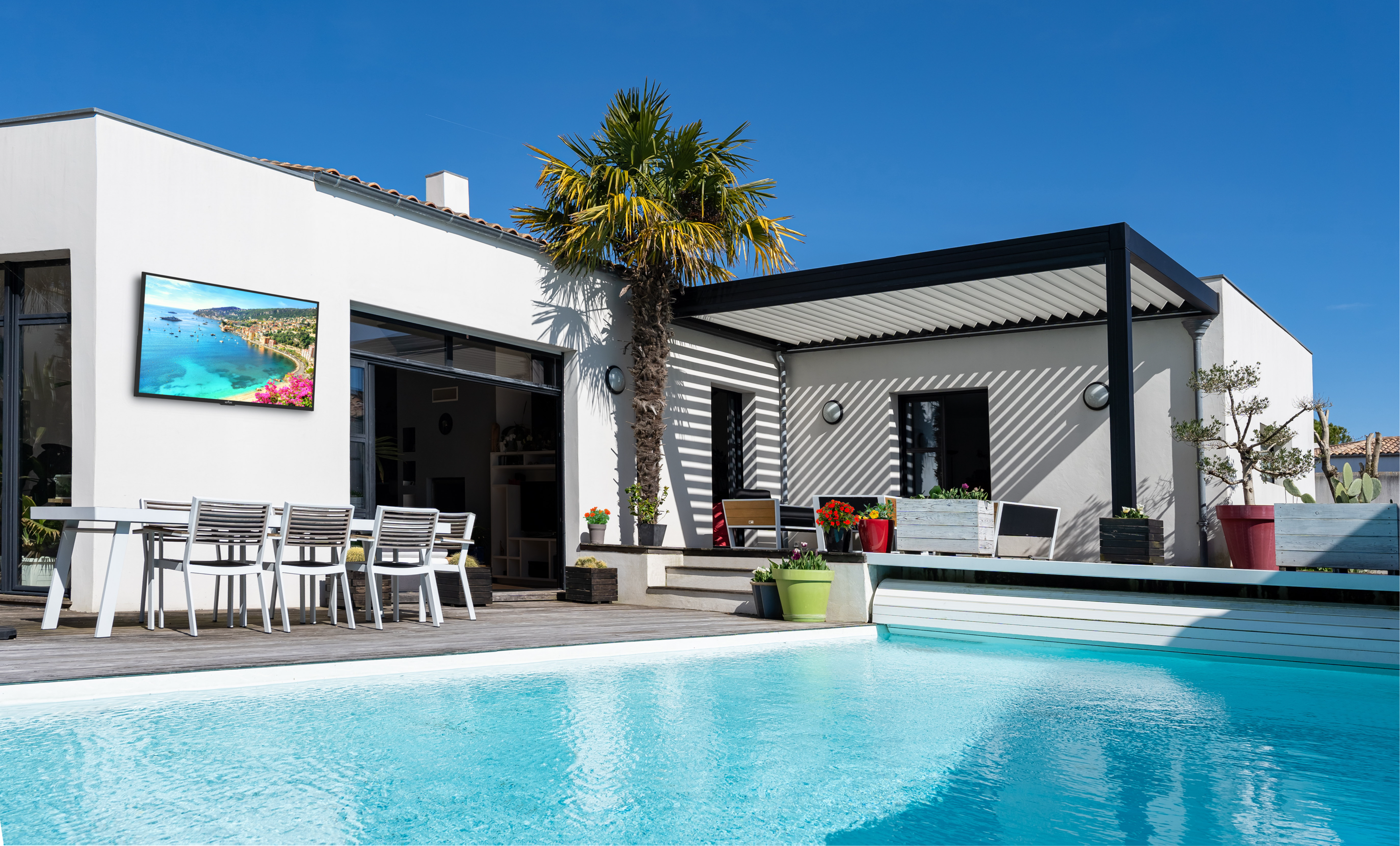 Modern house with pool, patio furniture, and clear blue sky.