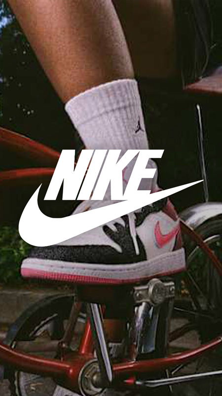 Person riding a bike wearing Nike shoes and socks.