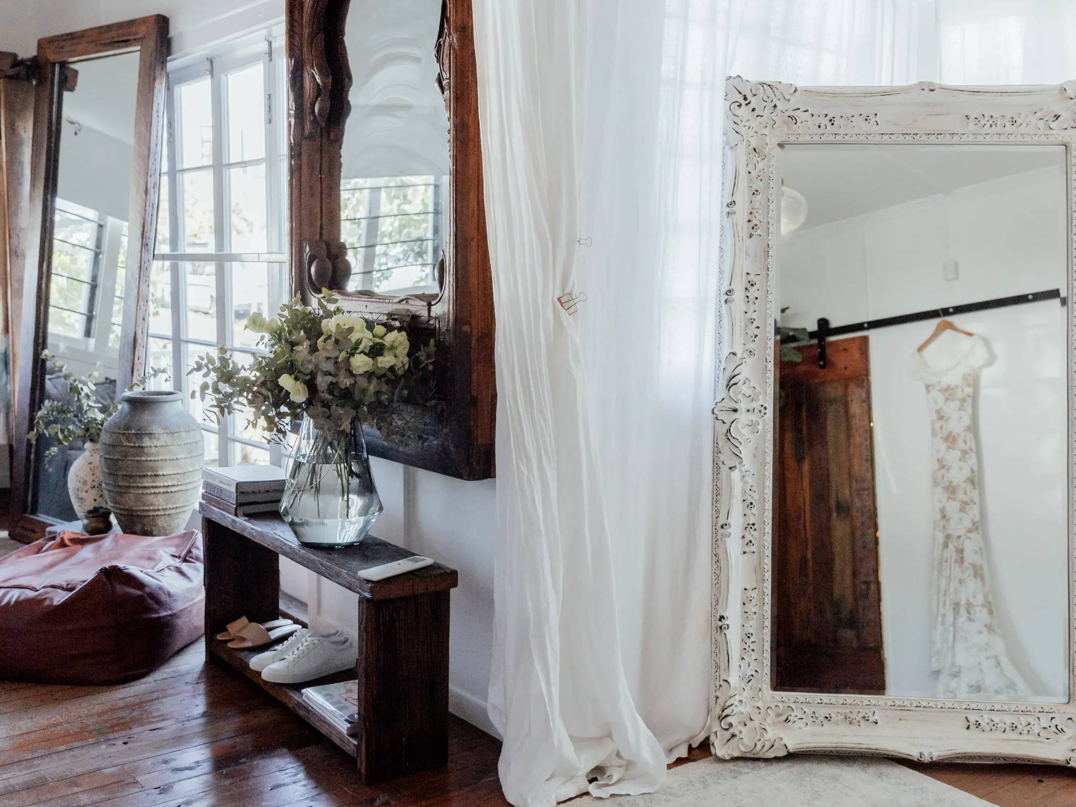 Trois grands miroirs et un décor bohème dans une boutique de mariage