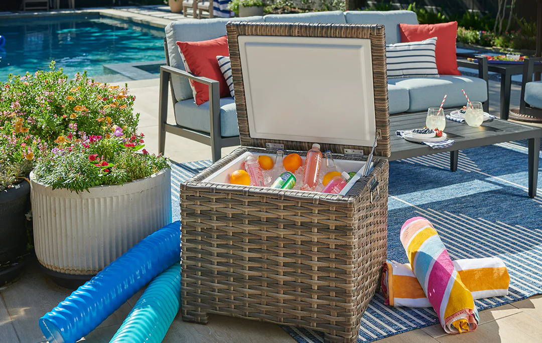 Poolside lounge chairs and a storage box with colorful items.