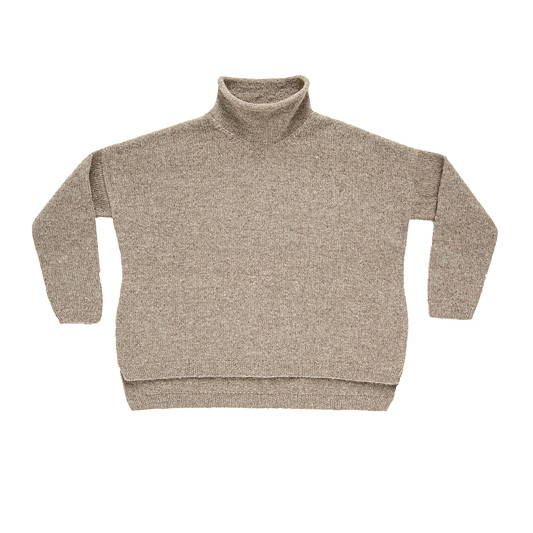A hand knit long-sleeved turtleneck sweater with a vented high-low hem photographed flat on a white background
