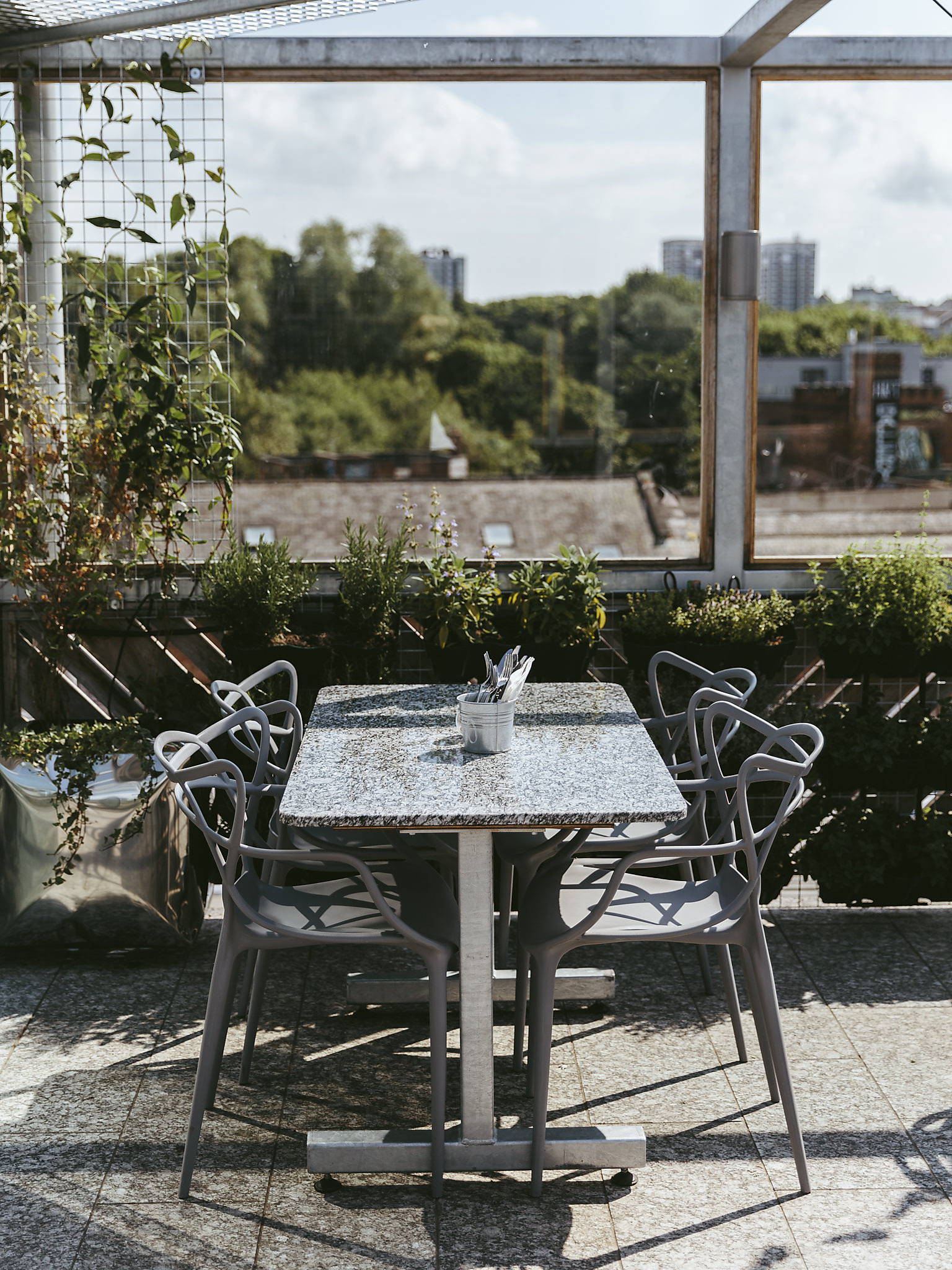 A table with four chairs on the sunny roof terrace at The Factory Kitchen cafe Newcastle.