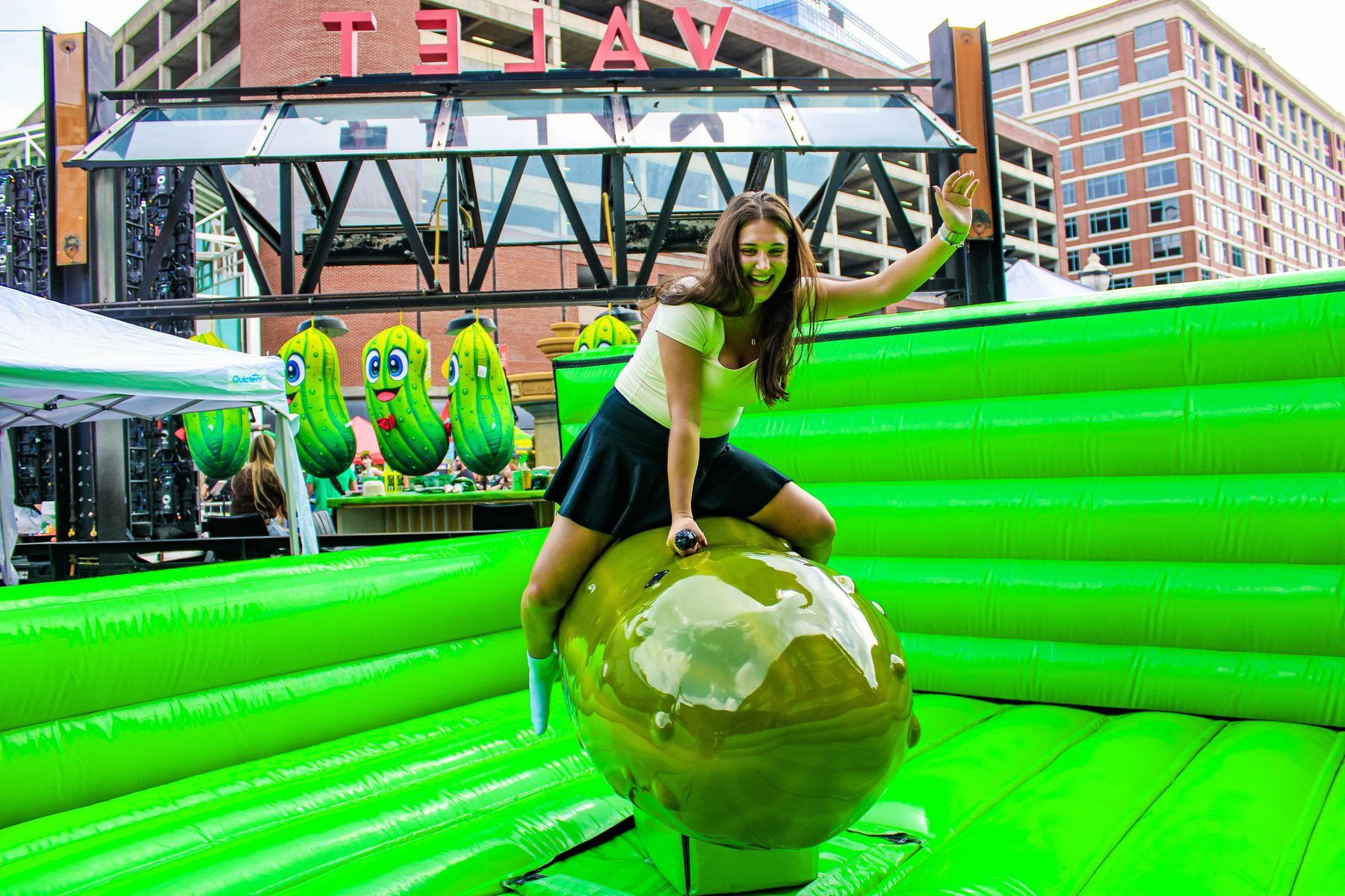 Guest riding the inflatable Pickle Rodeo bull at The Big Dill Power Plant Live in Baltimore.
