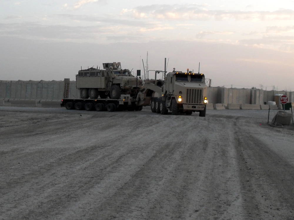 296th Transportation Co. from Brookhaven, Miss. practices maneuvering their Heavy Equipment Transporter, carrying a Mine Resistant Ambush Protected vehicle. The 296th TC, 260th Combat Sustainment Support Battalion, 96th Sustainment Brigade, 13th Sustainment Command (Expeditionary), carries various types of cargo throughout the Baghdad area of operations and must continually refine their driving skills.