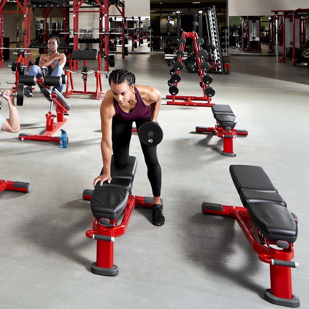 Female completing dumbbell row on Signature Series bench