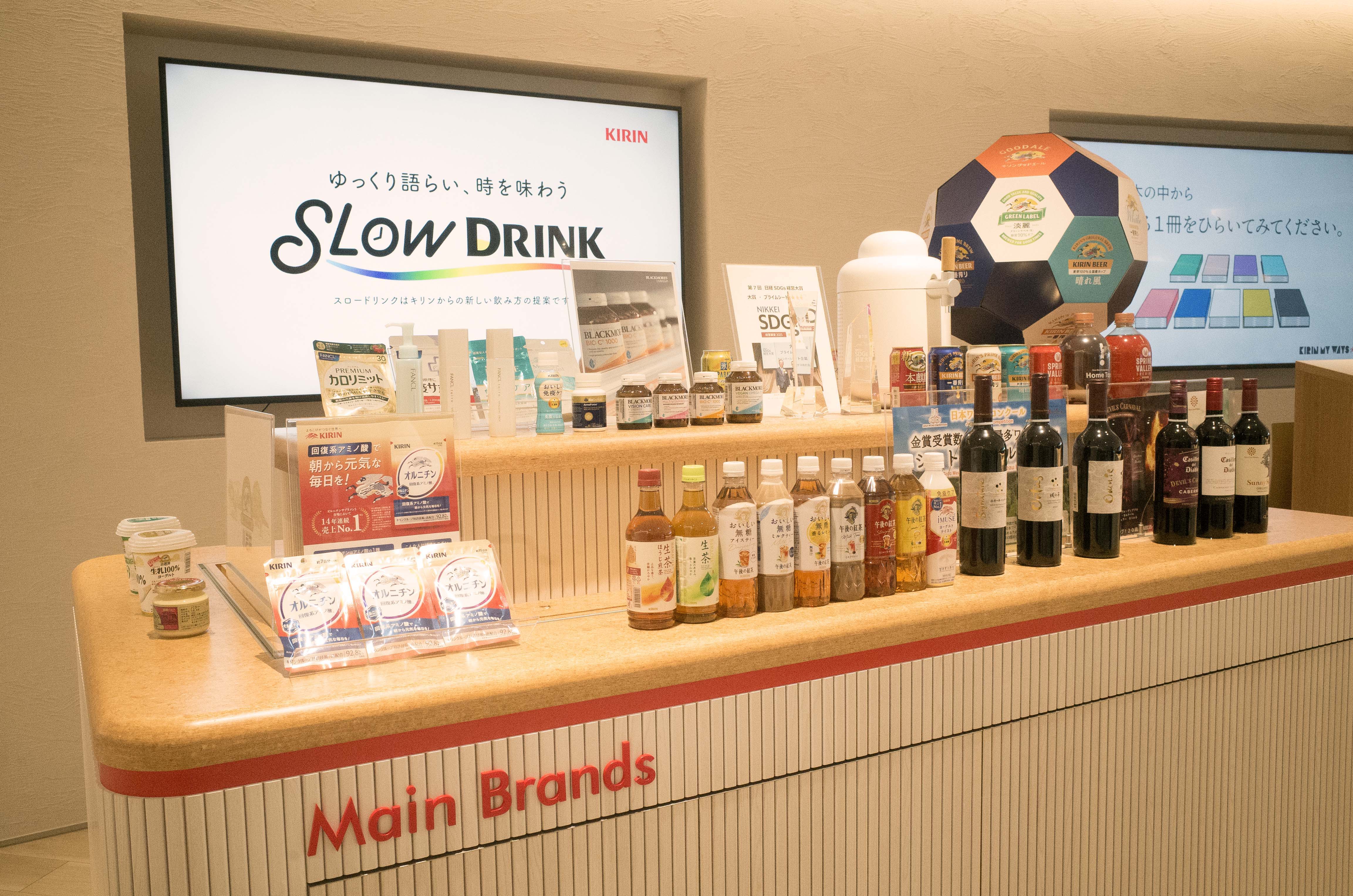 Display of various beverages and products at a retail counter.