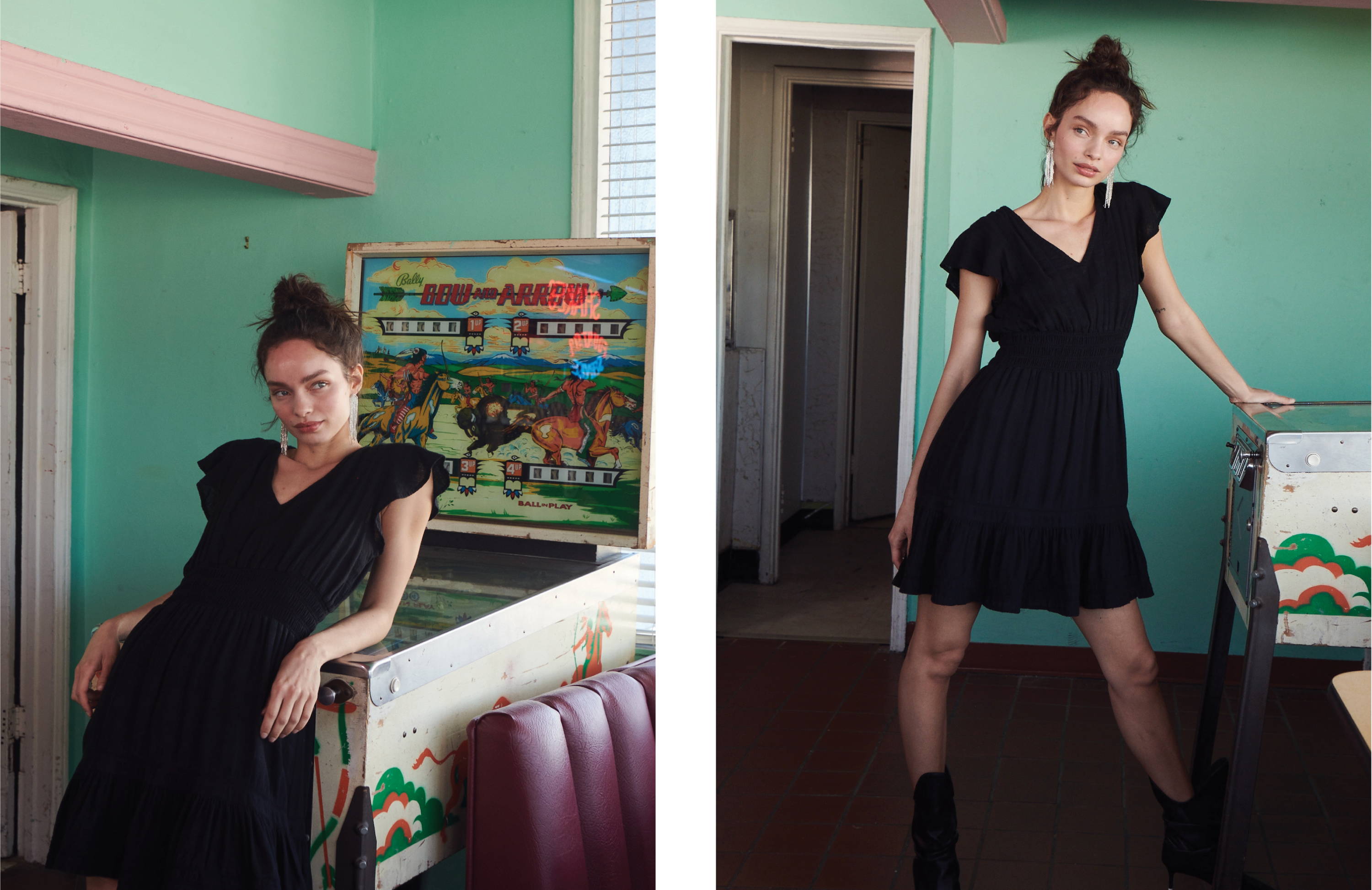 Model in front of pinball machine wearing Tara black lace detail dress