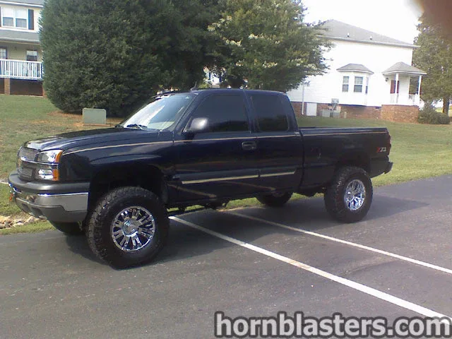 Front-three-quarter 2005 Chevrolet Silverado 1500 full-size pickup grille headlights bumper Shocker XL train horns featured customer install photo 1