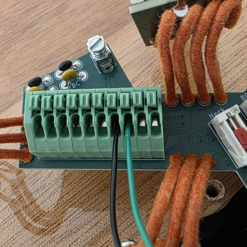 Close-up of a circuit board with multiple connections and wires.
