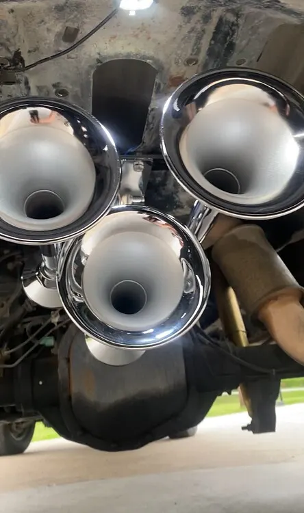 Three polished chrome train horns mounted to the undercarriage of Troy's Ford F250