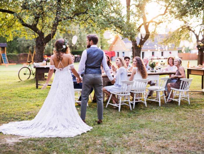 Bride and groom at backyard wedding with guests