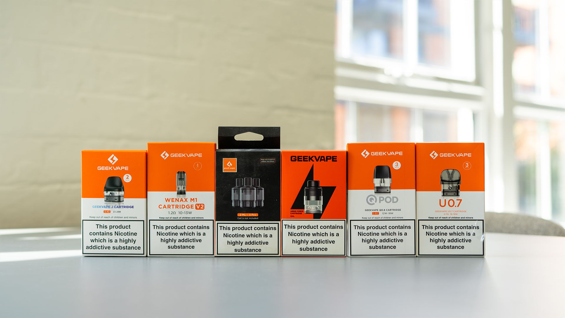 A picture of all the Geek Vape pods lined up on table 