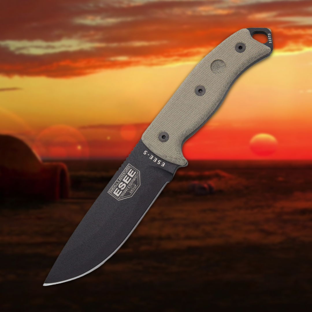 A knife with a gray handle against a sunset background.