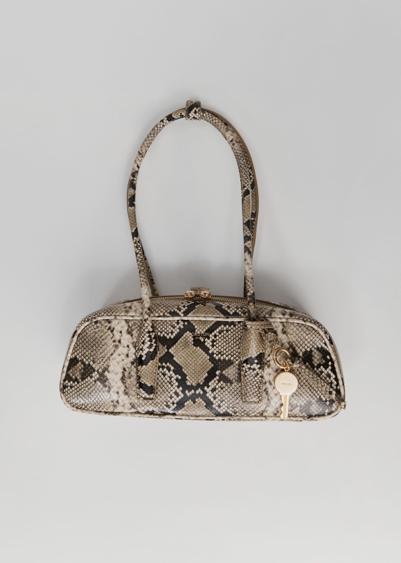Stylish handbag with a snake print design and two handles.