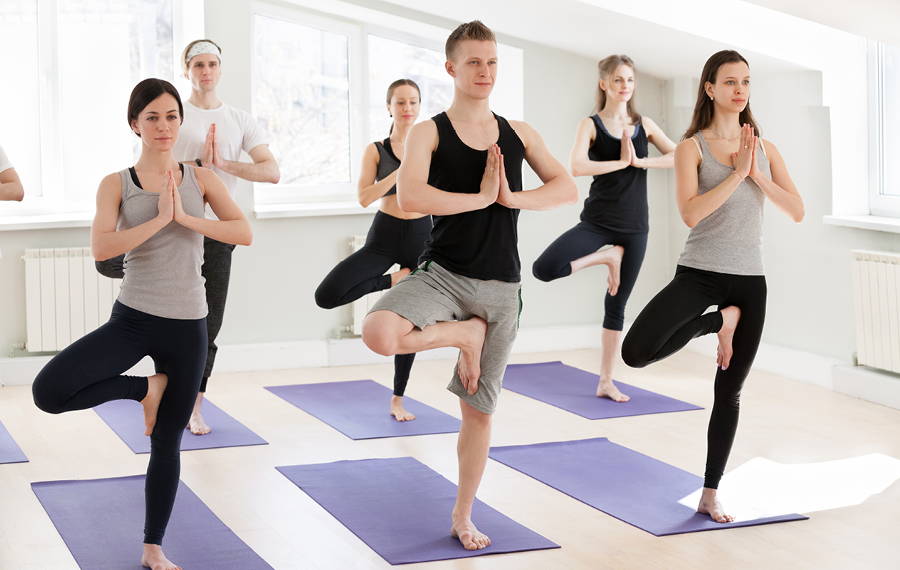 group of people doing yoga in a class