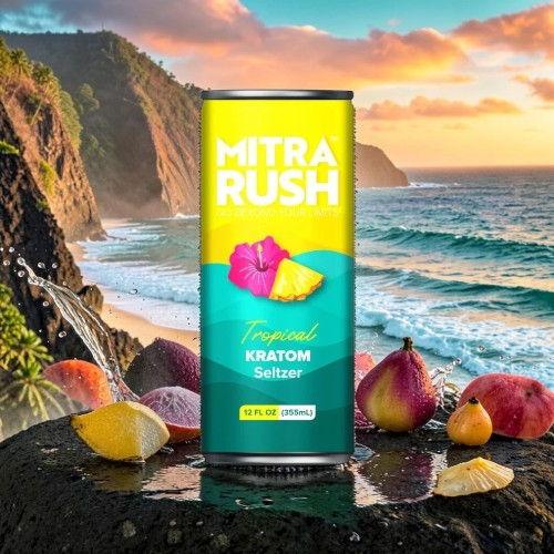Mitra Rush tropical beverage can on a rocky beach with fruits and sunset.