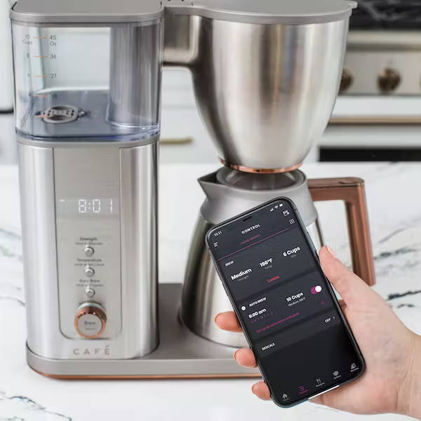 smartHQ app on phone by cafe coffee maker