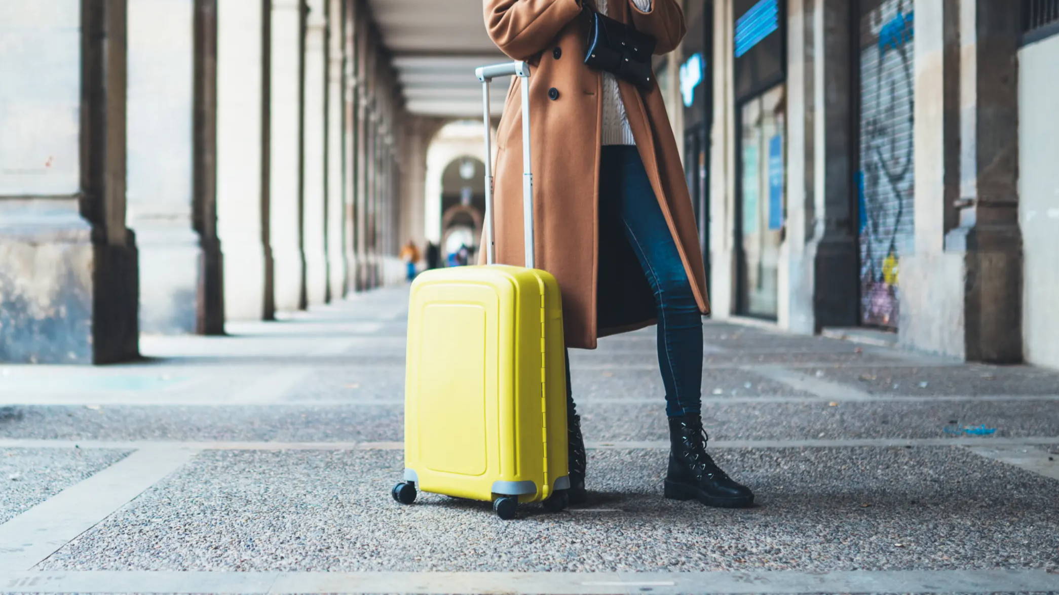 Female standing with luggage while travling