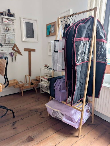 hanging project storage in a sewing room with project bags and garment project bags