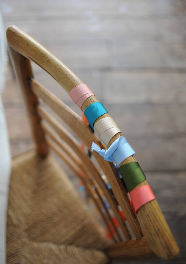 A birdeye view image of ribbons tied to a chair.