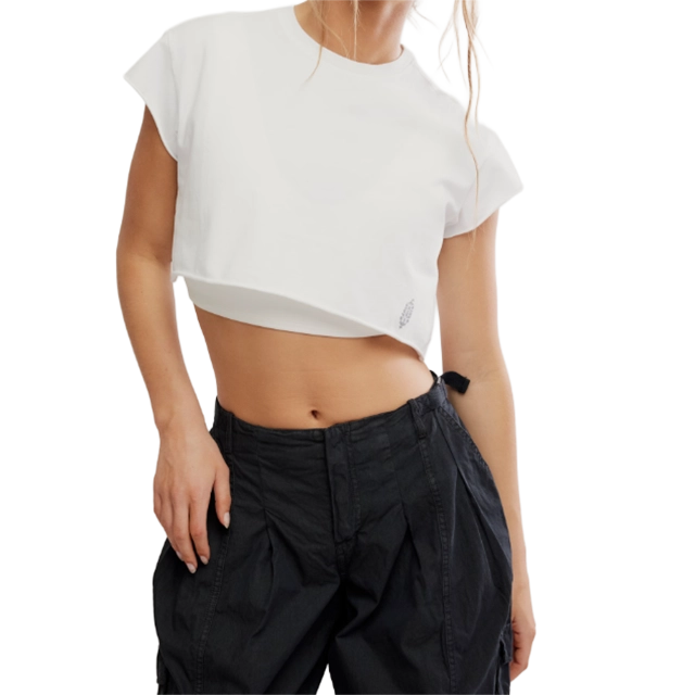 Woman wearing a cropped white t-shirt and black pants.