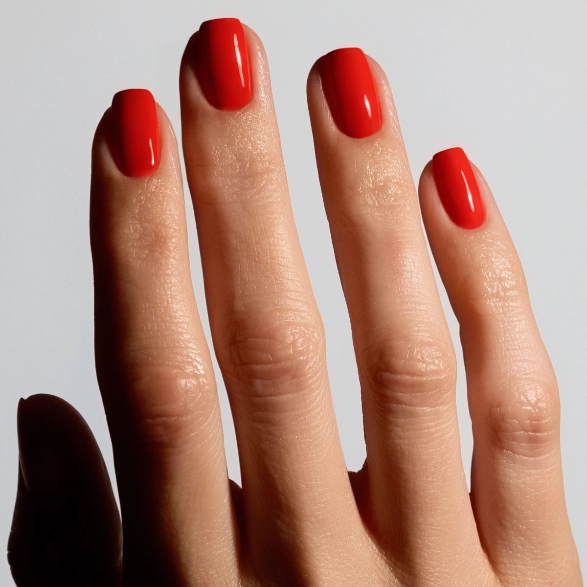 Shade Tropic from Glossify's Endless Summer collection on a light skin tone.