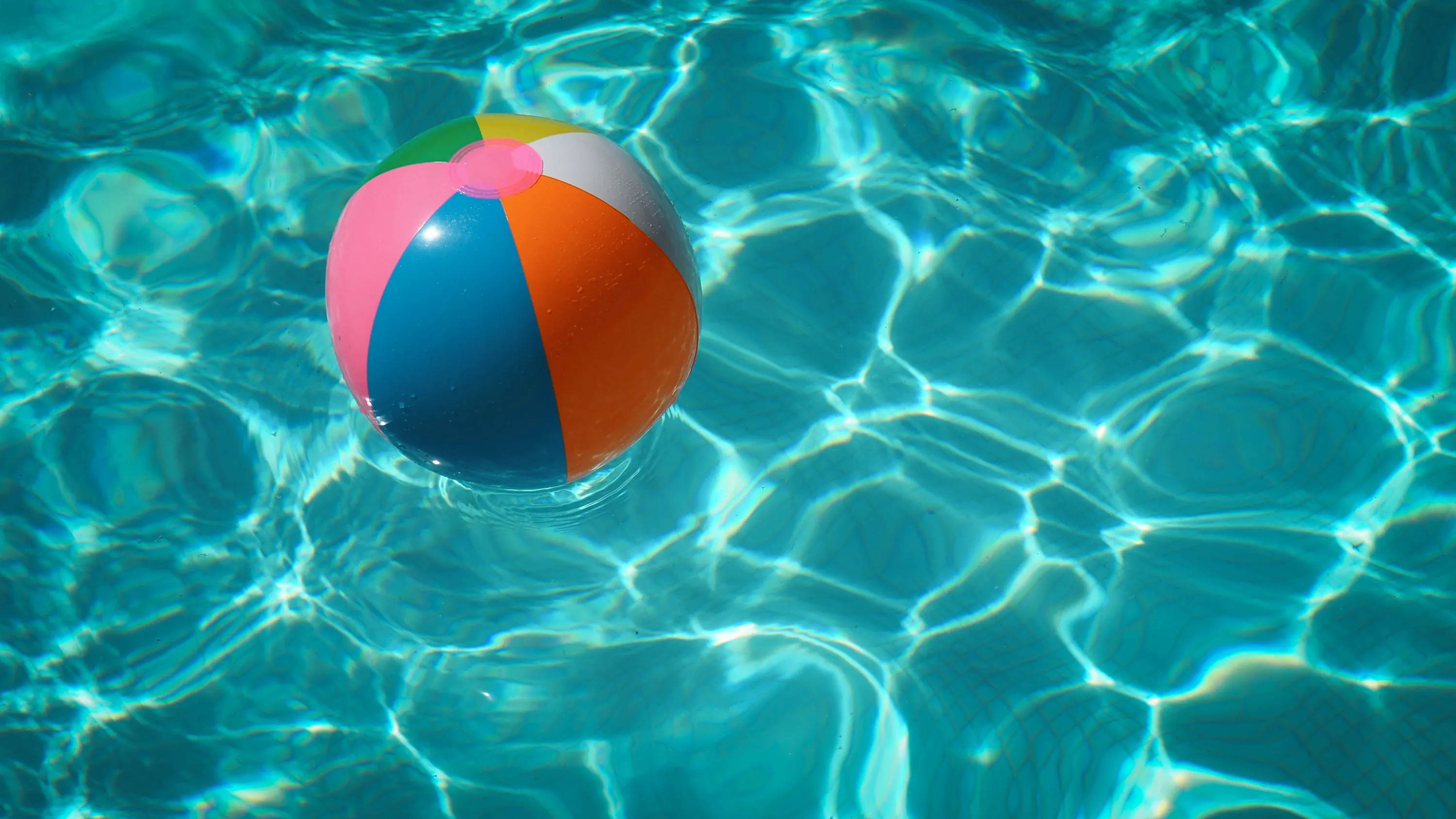 Blow up ball in pool during summer.