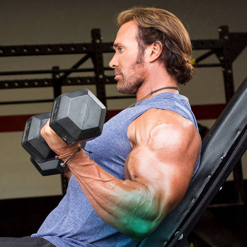 Photo of Mike O'Hearn doing seated bicep curls