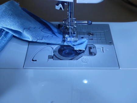 Sewing over a folded piece of fabric to make a mitered corner