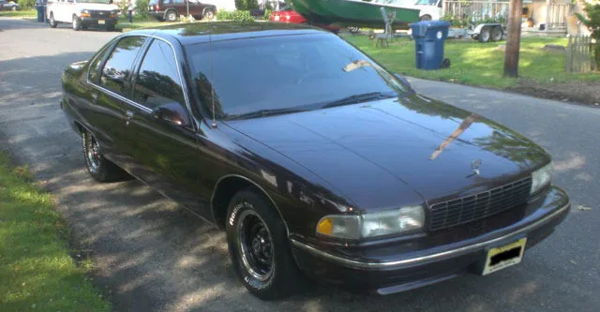 Front-three-quarter maroon 1996 Chevrolet Caprice full-size sedan BFGoodrich white-letter tires Jack's Conductor's Special 232 train horn kit featured customer install gallery photo 1