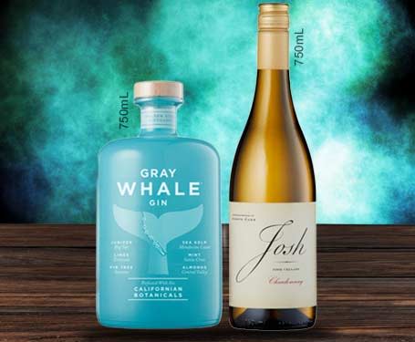 Bottle of Gray Whale gin and Josh wine on a wooden surface.