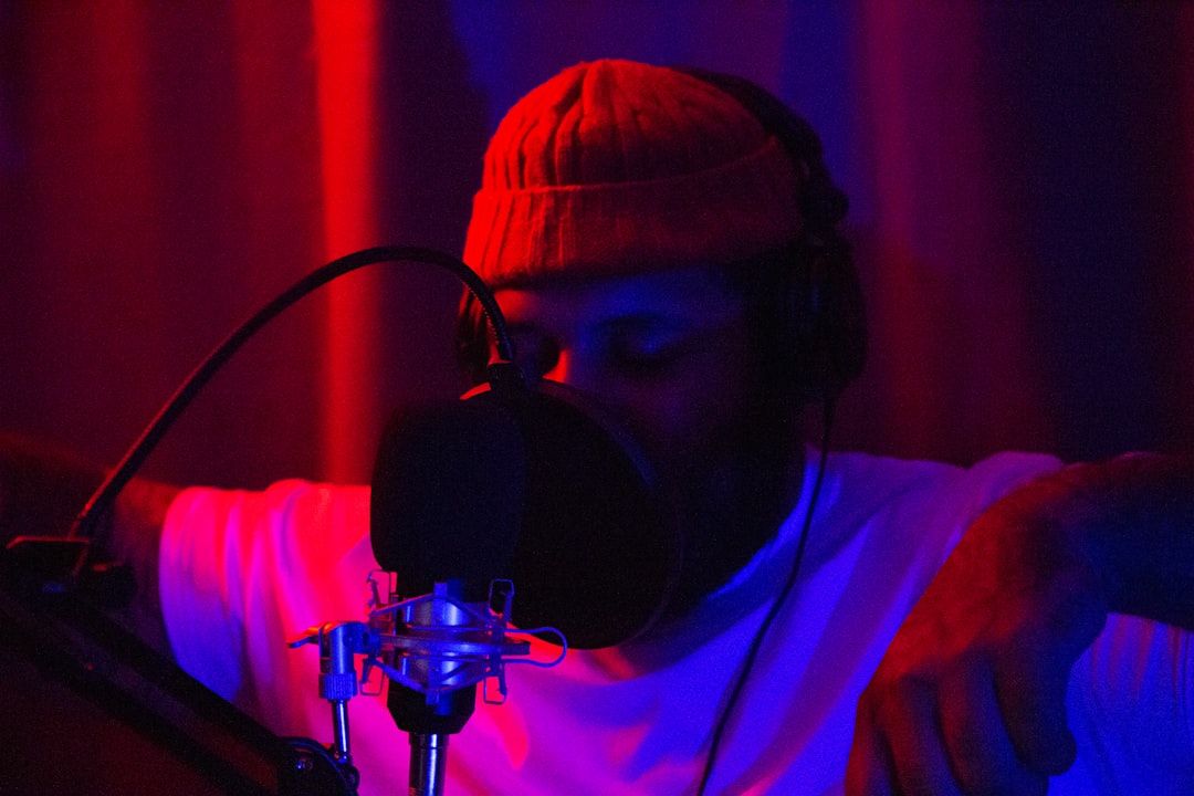 man in white shirt wearing black headphones