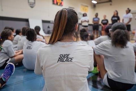 heroes basketball league girls listening to speaker