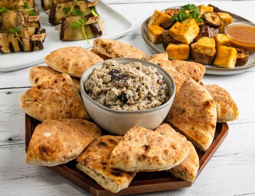 A platter of bread, rice, and side dishes.