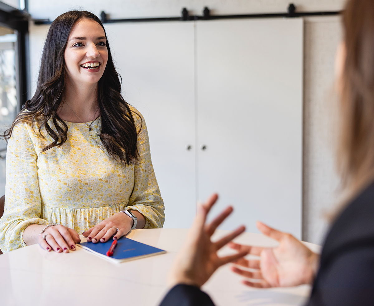 A woman with aphasia and a clinician during the evaluation stage of the AAC process 