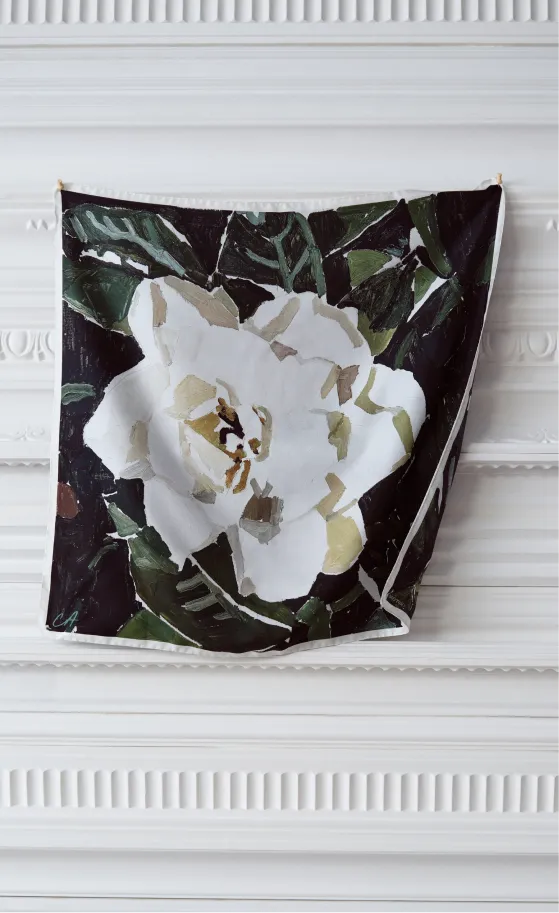 A floral artwork featuring a white flower against a dark background.