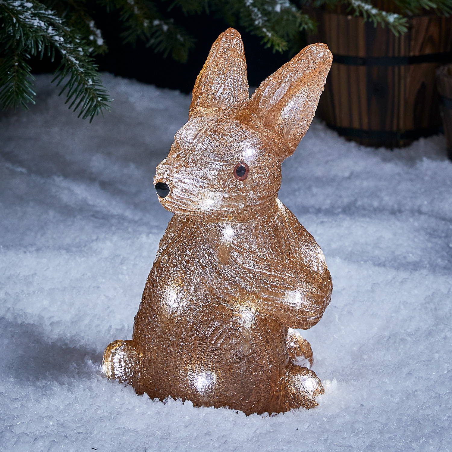 Acrylic bunny Christmas figure in an outdoor snowy setting.