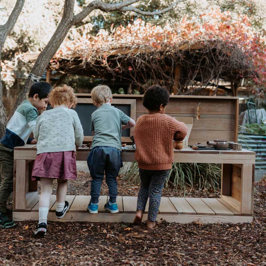 Children playing with a mud kitchen