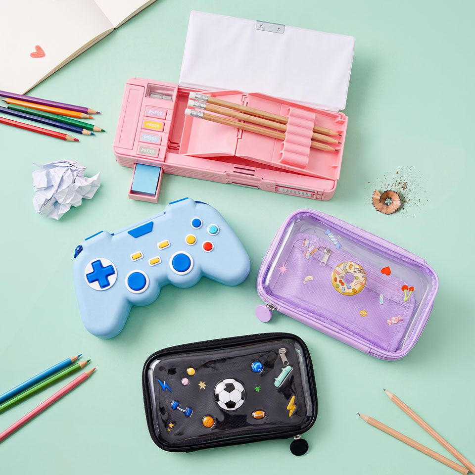 Colorful pencil cases and craft supplies arranged on a light green background.