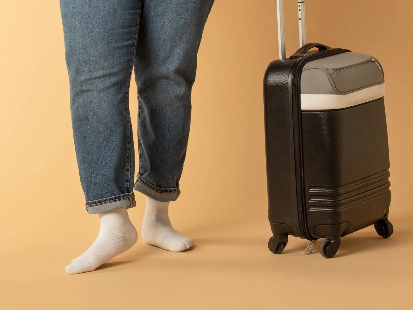 Woman standing with luggage while wearing Core-Spun Gradient Compression Socks in White