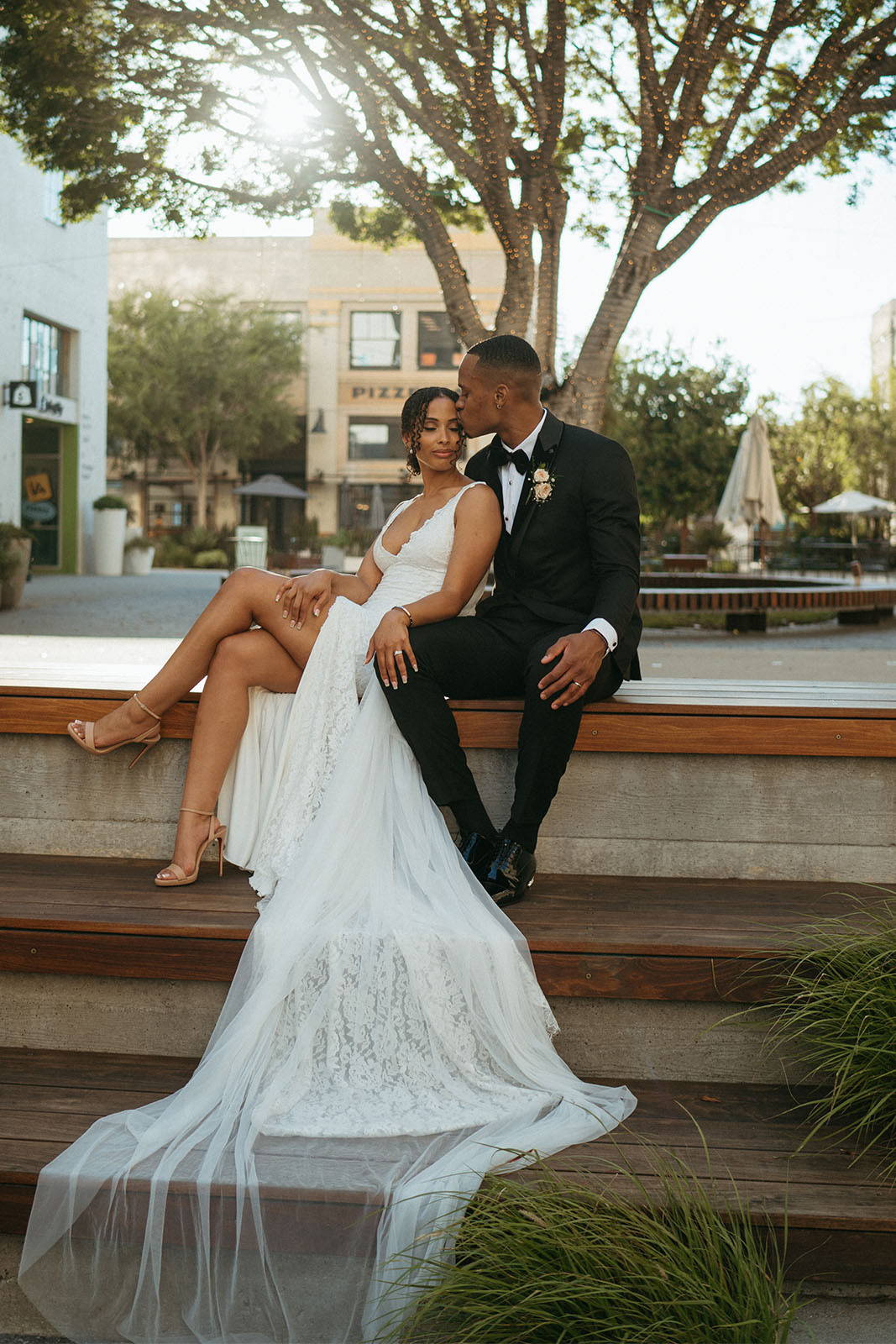 Bride and groom sitting on staircase