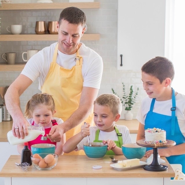 Image of dad making cake with kids