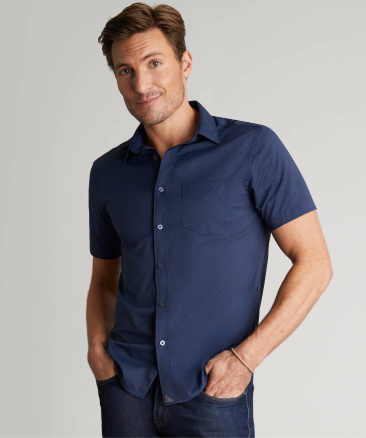 Model is wearing UNTUCKit short sleeve gironde shirt in blue. 
