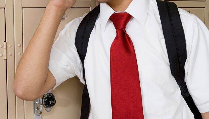 Student wearing red necktie in school hallway