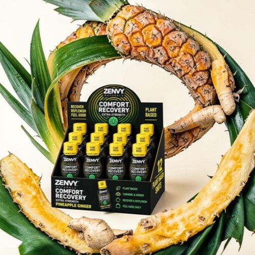 Zenny Comfort Recovery drink displays surrounded by pineapple and ginger.